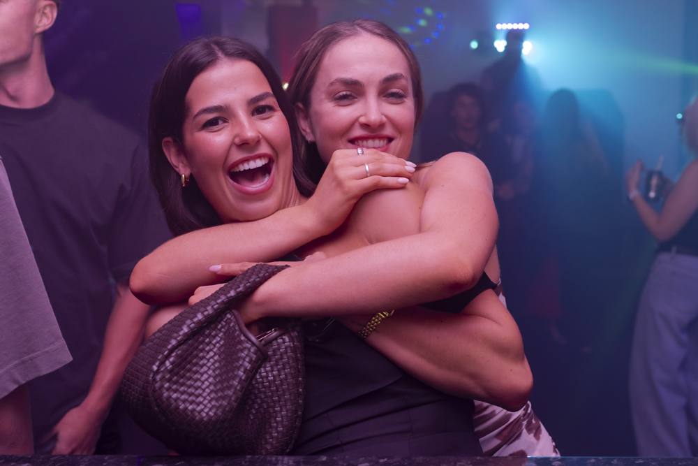 Friends hugging on the dance floor