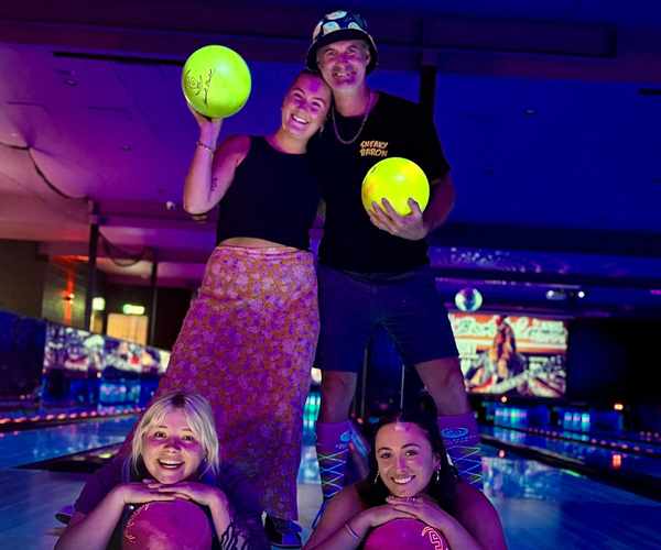 Group of friends holding bowling balls at Spinners Bar & Bowl Maroochydore