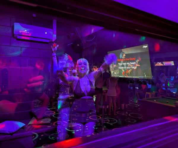 Private karaoke room with neon lighting and lyrics screen at Spinners Maroochydore