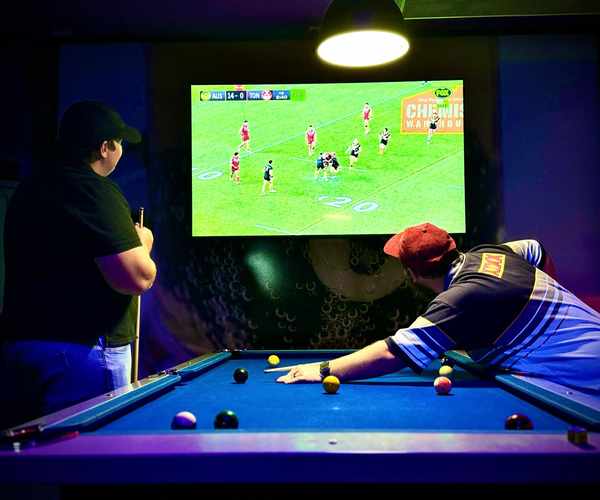 Playing pool while watching live sport on big screen at Spinners Maroochydore
